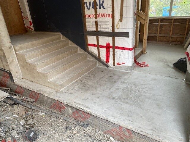 Worn and failing pedestrian traffic coating on a strata walkway before repair by West Coast Waterproofing
