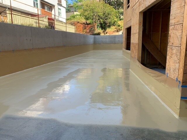 Spray-applied polyurea membrane being installed by West Coast Waterproofing
