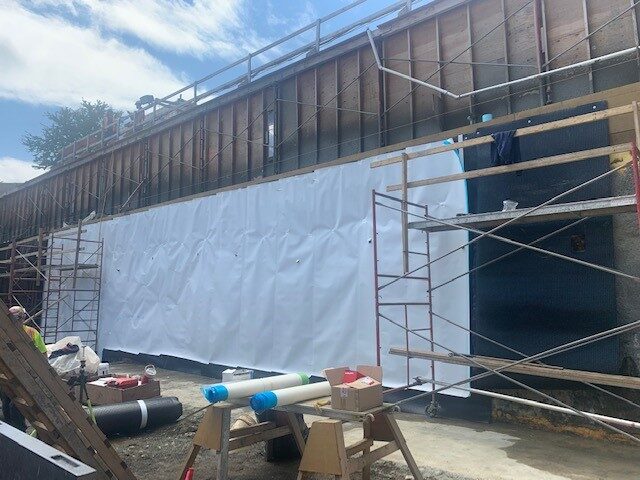 Blindside pre-applied waterproofing membrane installed against shoring by West Coast Waterproofing