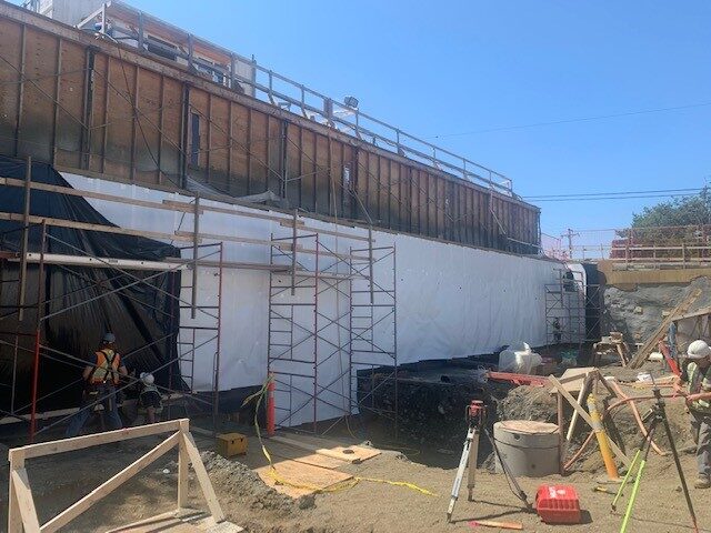 Blindside pre-applied waterproofing membrane installed against shoring by West Coast Waterproofing