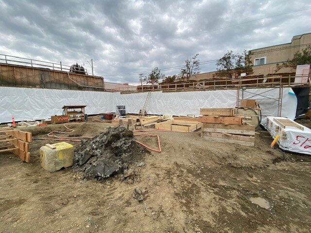 Blindside pre-applied waterproofing membrane installed against shoring by West Coast Waterproofing